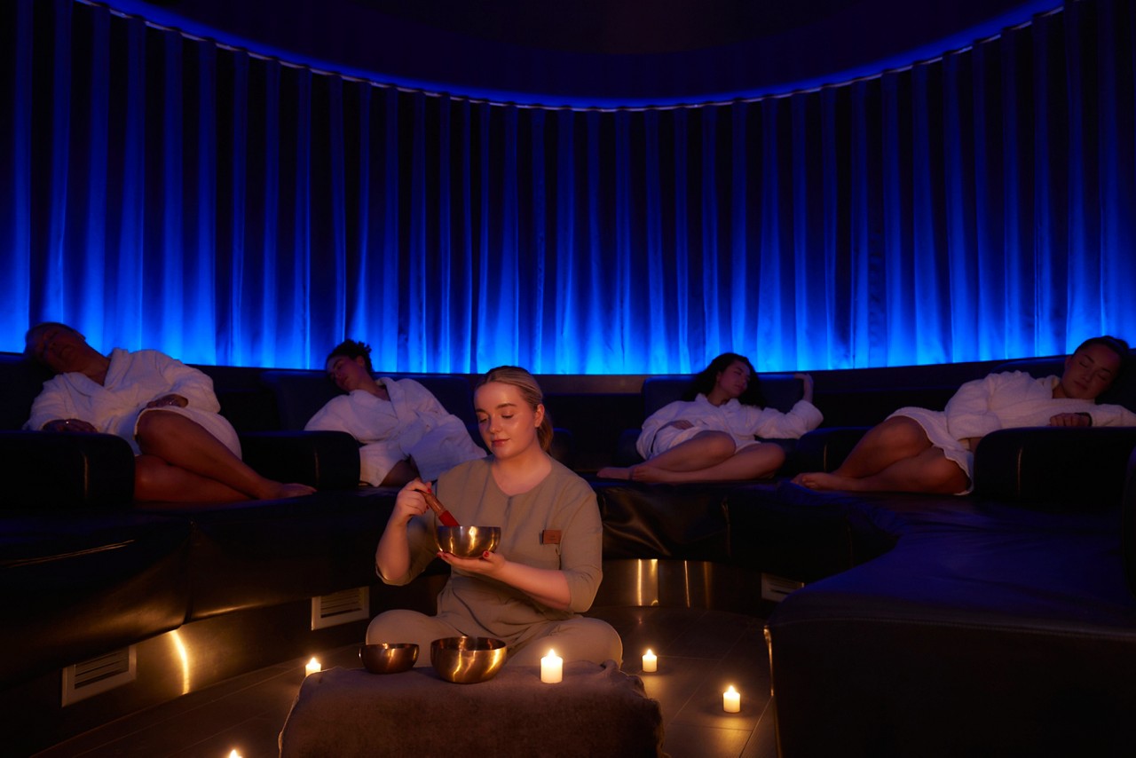 Spa therapist running a Sound Bathing session.